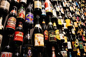 A wall of Belgian beer bottles at the Bruges beer experience.jpg